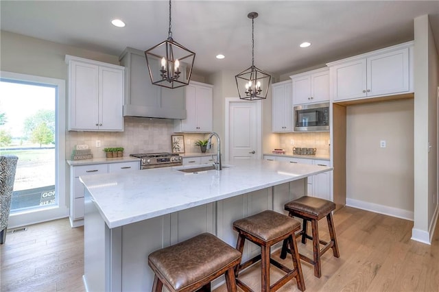 24110 W 95th St, Lenexa, KS 66227 - kitchen featuring stainless steel appliances, a chandelier, light wood-style floors, white cabinetry, and recessed lighting