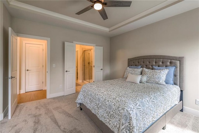 24110 W 95th St, Lenexa, KS 66227 - bedroom featuring carpet floors, a raised ceiling, connected bathroom, and ceiling fan
