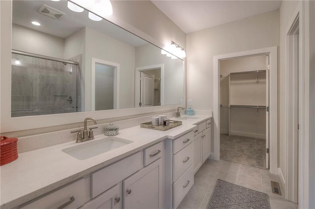 24110 W 95th St, Lenexa, KS 66227 - full bath with double vanity, a shower stall, a spacious closet, and tile patterned floors