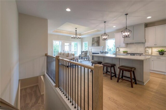 24110 W 95th St, Lenexa, KS 66227 - kitchen with tasteful backsplash, healthy amount of natural light, white cabinets, a kitchen bar, and recessed lighting