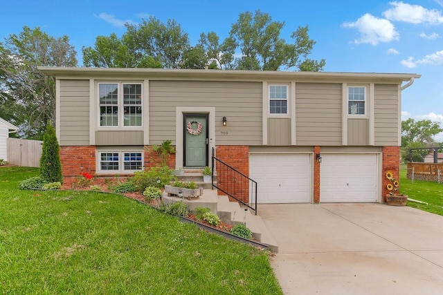 709 S 9th St, Louisburg, KS 66053 - view of front of house featuring brick siding, a garage, and driveway