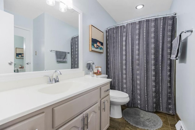 709 S 9th St, Louisburg, KS 66053 - full bathroom with a baseboard heating unit, vanity, and tile patterned floors