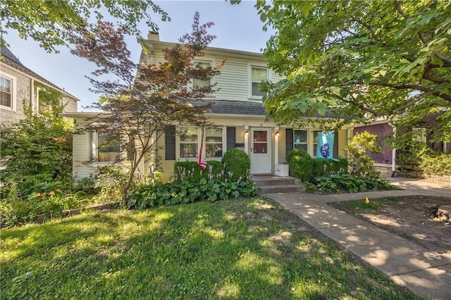 11 W 70th St, Kansas City, MO 64113 - obstructed view of property with a chimney and a front lawn