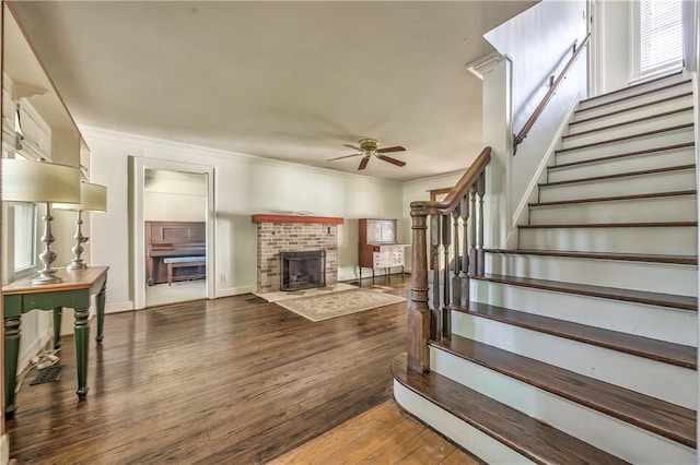 11 W 70th St, Kansas City, MO 64113 - living area featuring a ceiling fan, stairway, ornamental molding, wood finished floors, and a fireplace