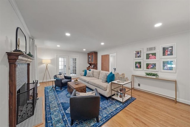 8315 Lee Blvd, Leawood, KS 66206 - living room featuring ornamental molding, wood finished floors, recessed lighting, a fireplace, and french doors