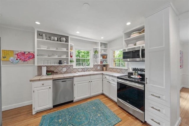 8315 Lee Blvd, Leawood, KS 66206 - kitchen with open shelves, stainless steel appliances, tile countertops, white cabinets, and recessed lighting