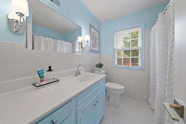 8315 Lee Blvd, Leawood, KS 66206 - full bathroom with tile walls, vanity, tile patterned floors, a wainscoted wall, and a shower with curtain