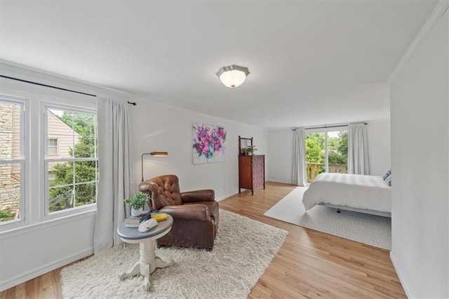8315 Lee Blvd, Leawood, KS 66206 - bedroom featuring multiple windows, light wood-style flooring, and ornamental molding