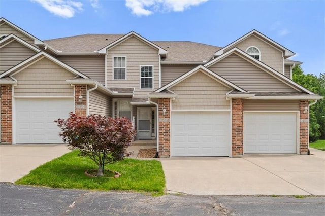 3568 NE Austin Dr, Lees Summit, MO 64064 - view of front of house featuring driveway, brick siding, and roof with shingles