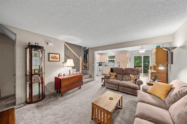 3568 NE Austin Dr, Lees Summit, MO 64064 - living area featuring light carpet, a ceiling fan, a textured ceiling, and stairs