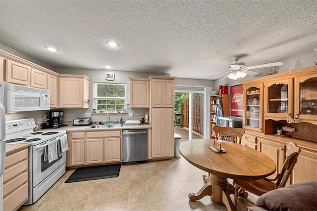 3568 NE Austin Dr, Lees Summit, MO 64064 - kitchen with white appliances, light brown cabinets, light countertops, a ceiling fan, and a textured ceiling