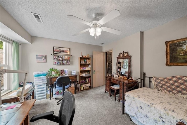 3568 NE Austin Dr, Lees Summit, MO 64064 - bedroom with a desk, light colored carpet, a textured ceiling, and a ceiling fan