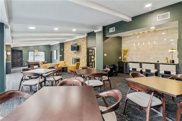4545 Wornall Rd Unit Le4, Kansas City, MO 64111 - dining area featuring beamed ceiling, carpet, a fireplace, recessed lighting, and a community bar