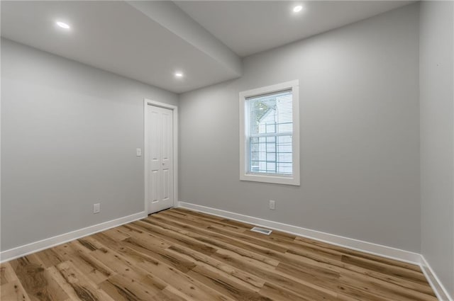 410 Kensington Ave, Kansas City, MO 64124 - empty room with wood finished floors and recessed lighting