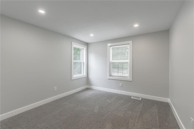 410 Kensington Ave, Kansas City, MO 64124 - empty room with dark colored carpet and recessed lighting