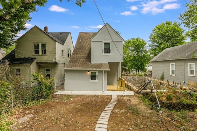 410 Kensington Ave, Kansas City, MO 64124 - back of property with a shingled roof