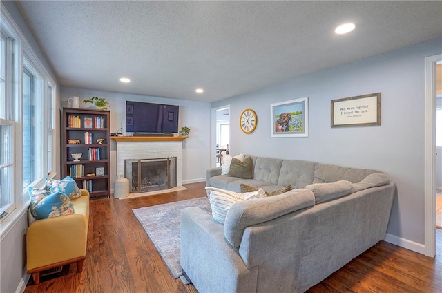 11325 W 54th St, Shawnee, KS 66203 - living room featuring a textured ceiling, wood finished floors, a fireplace, and recessed lighting