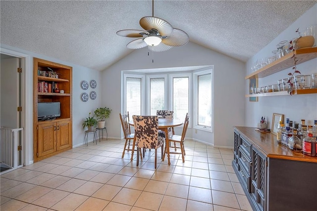 11325 W 54th St, Shawnee, KS 66203 - dining room with lofted ceiling, a ceiling fan, a textured ceiling, built in shelves, and light tile patterned floors