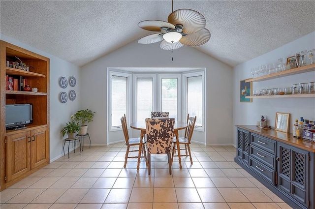 11325 W 54th St, Shawnee, KS 66203 - dining room with lofted ceiling, a textured ceiling, ceiling fan, and light tile patterned floors