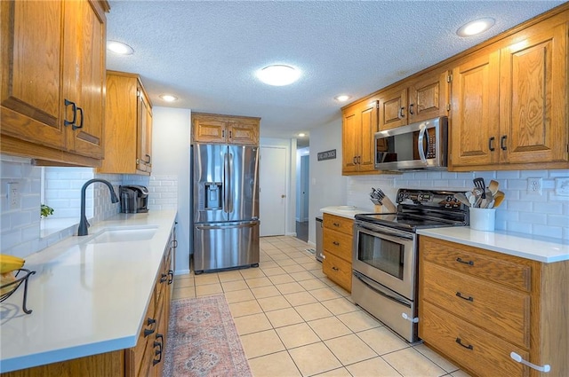 11325 W 54th St, Shawnee, KS 66203 - kitchen with appliances with stainless steel finishes, brown cabinets, light tile patterned flooring, light countertops, and decorative backsplash