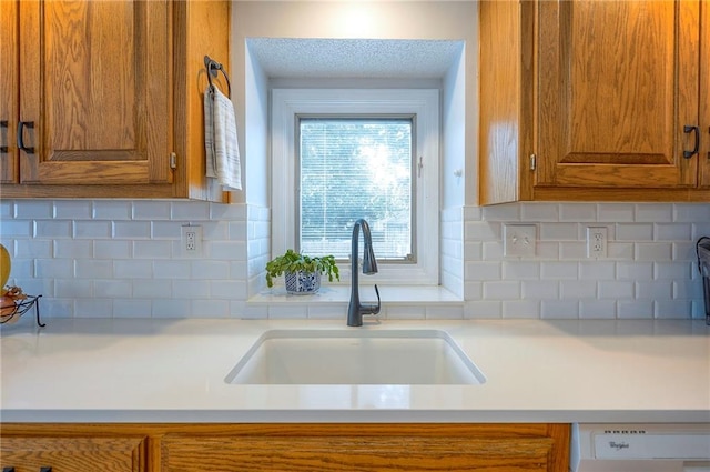 11325 W 54th St, Shawnee, KS 66203 - kitchen featuring brown cabinetry, light countertops, and decorative backsplash