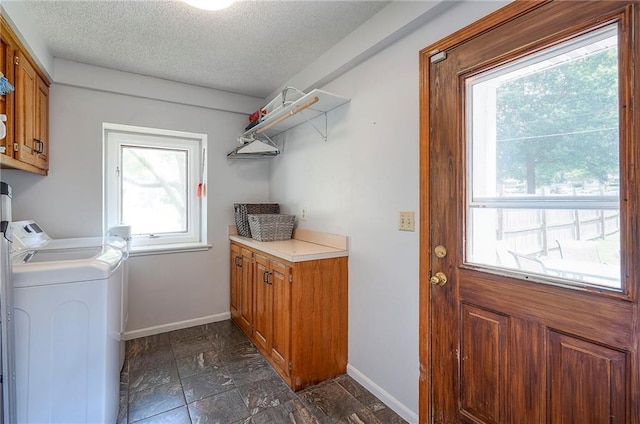 11325 W 54th St, Shawnee, KS 66203 - laundry room featuring cabinet space, plenty of natural light, washer and dryer, a textured ceiling, and dark stone finish floors