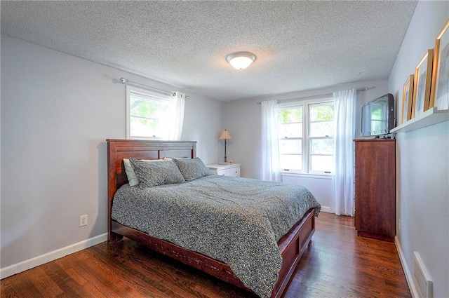 11325 W 54th St, Shawnee, KS 66203 - bedroom featuring dark wood-style floors, multiple windows, and a textured ceiling