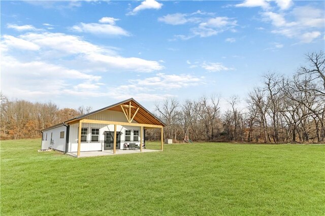 501 NW 101st Rd, Warrensburg, MO 64093 - back of property with a patio and a lawn