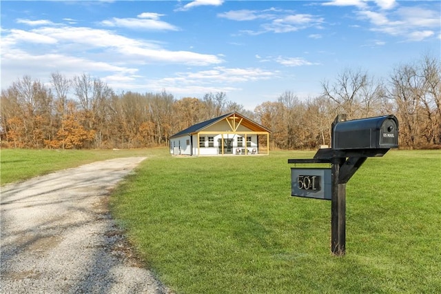501 NW 101st Rd, Warrensburg, MO 64093 - view of front facade with a front yard and driveway