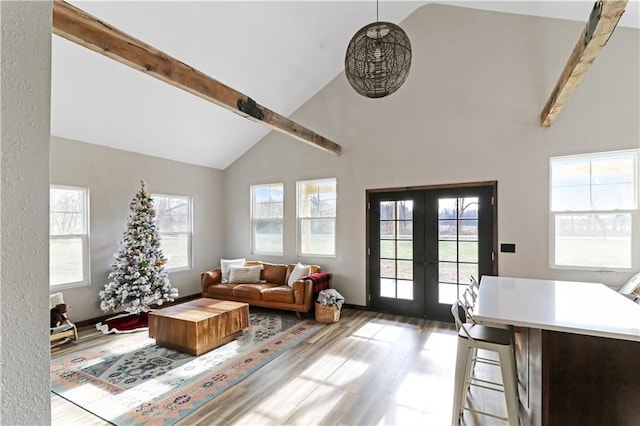 501 NW 101st Rd, Warrensburg, MO 64093 - living area with wood finished floors, french doors, high vaulted ceiling, beamed ceiling, and plenty of natural light