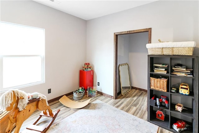 501 NW 101st Rd, Warrensburg, MO 64093 - bedroom featuring light wood-type flooring and baseboards