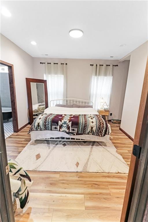 501 NW 101st Rd, Warrensburg, MO 64093 - bedroom featuring multiple windows and light wood-type flooring