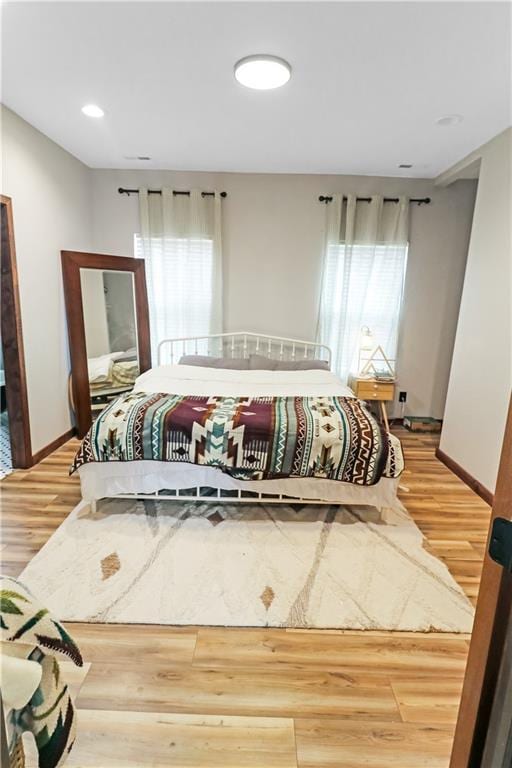 501 NW 101st Rd, Warrensburg, MO 64093 - bedroom with multiple windows and light wood-style floors