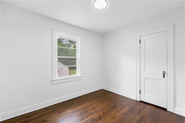 6806 N Brookside Rd, Pleasant Valley, MO 64068 - empty room featuring dark wood-style floors and baseboards