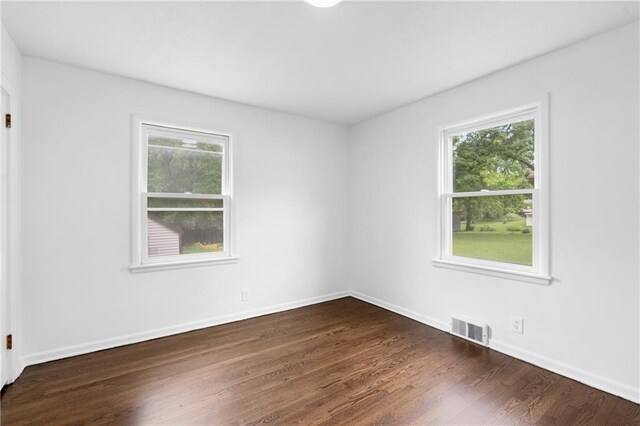 6806 N Brookside Rd, Pleasant Valley, MO 64068 - spare room with plenty of natural light and dark wood finished floors