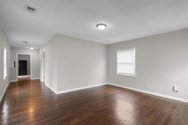 1646 Bennington Ave, Kansas City, MO 64126 - unfurnished room featuring plenty of natural light, wood-type flooring, and a textured ceiling