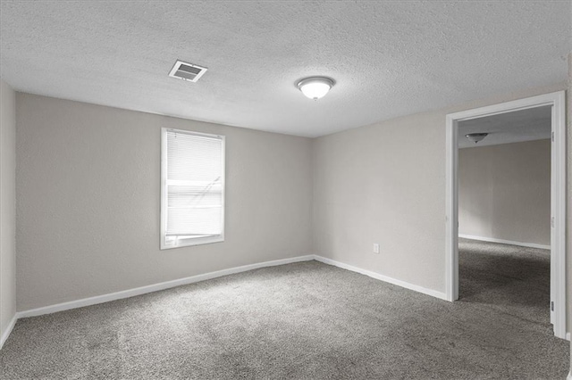 1646 Bennington Ave, Kansas City, MO 64126 - carpeted empty room with a textured ceiling and baseboards