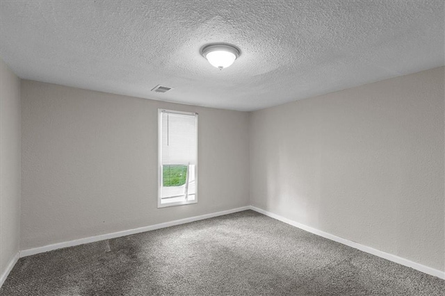 1646 Bennington Ave, Kansas City, MO 64126 - spare room with carpet and a textured ceiling