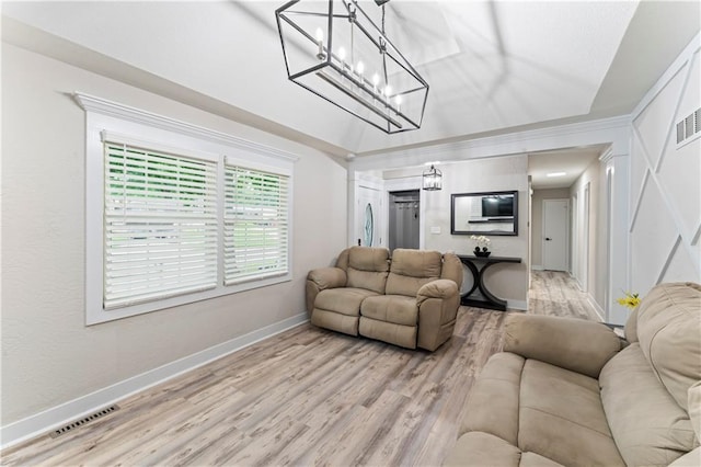3005 Elmira Ct, Independence, MO 64057 - living area with light wood finished floors, lofted ceiling, and a chandelier
