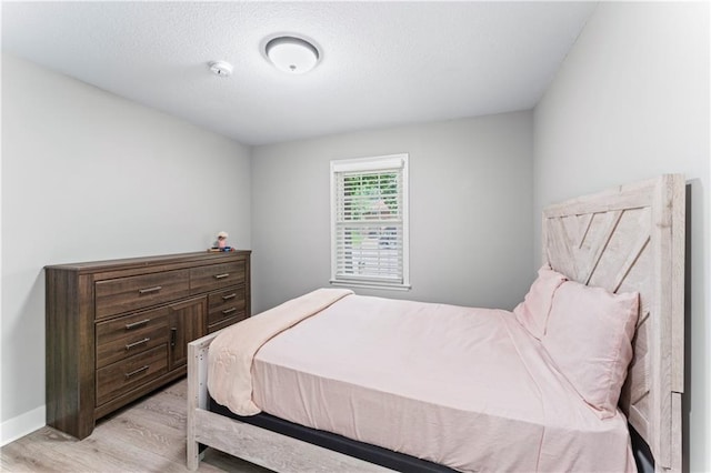 3005 Elmira Ct, Independence, MO 64057 - bedroom with light wood finished floors and a textured ceiling