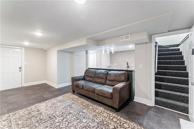 3005 Elmira Ct, Independence, MO 64057 - living area featuring a textured ceiling, stairs, and bar area