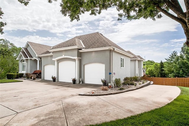 3401 NE 153rd Ter, Smithville, MO 64089 - view of home's exterior with an attached garage, driveway, stucco siding, and a shingled roof