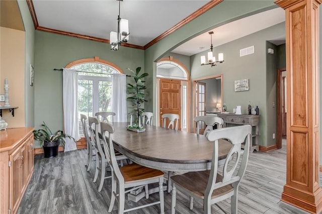 3401 NE 153rd Ter, Smithville, MO 64089 - dining area featuring a chandelier, wood finished floors, ornamental molding, and arched walkways