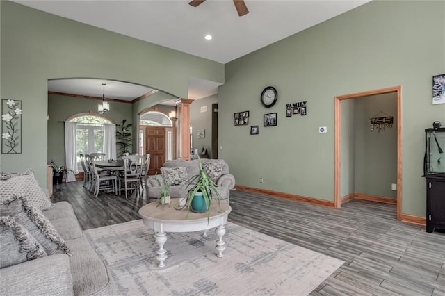 3401 NE 153rd Ter, Smithville, MO 64089 - living room with arched walkways, a ceiling fan, wood finished floors, ornate columns, and recessed lighting