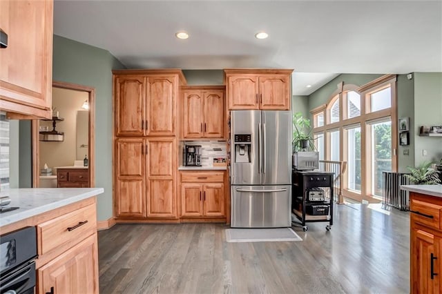 3401 NE 153rd Ter, Smithville, MO 64089 - kitchen featuring stainless steel fridge with ice dispenser, light countertops, wood finished floors, and recessed lighting