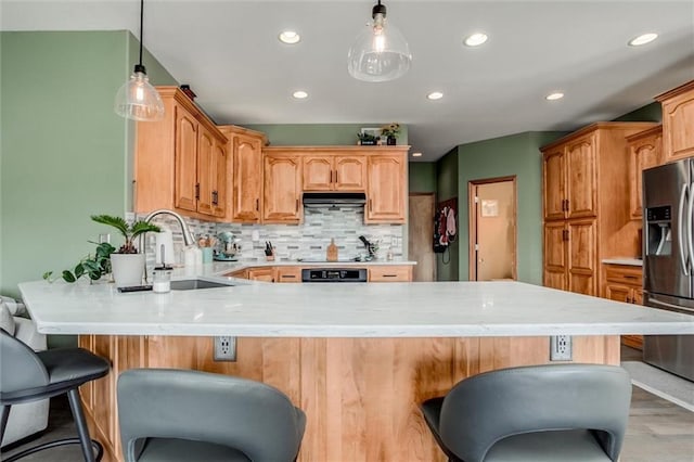 3401 NE 153rd Ter, Smithville, MO 64089 - kitchen featuring stainless steel refrigerator with ice dispenser, under cabinet range hood, a peninsula, a kitchen breakfast bar, and decorative backsplash