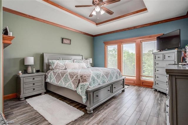 3401 NE 153rd Ter, Smithville, MO 64089 - bedroom with a raised ceiling, light wood-style flooring, crown molding, and a ceiling fan