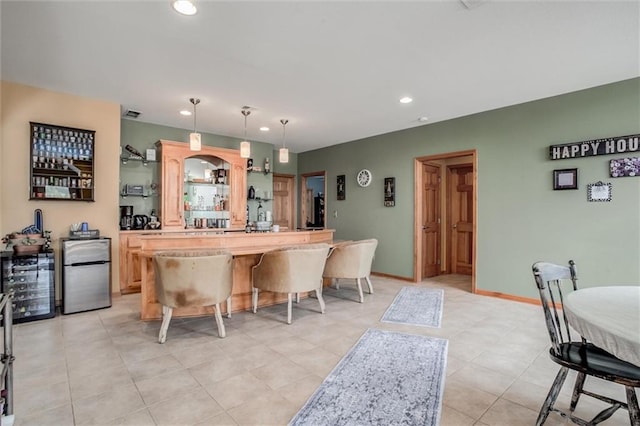 3401 NE 153rd Ter, Smithville, MO 64089 - kitchen featuring freestanding refrigerator, light brown cabinetry, recessed lighting, light countertops, and a kitchen bar