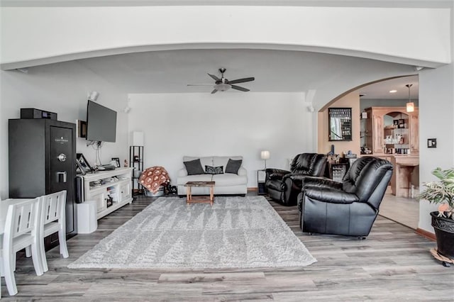3401 NE 153rd Ter, Smithville, MO 64089 - living area featuring arched walkways, wood finished floors, and ceiling fan