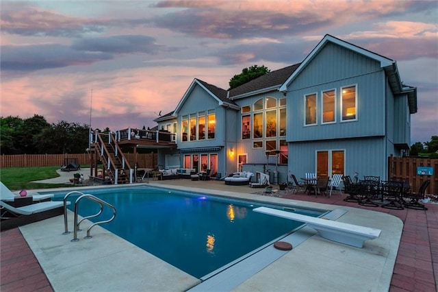 3401 NE 153rd Ter, Smithville, MO 64089 - back of house at dusk featuring stairway, outdoor lounge area, a fenced backyard, a patio, and a deck